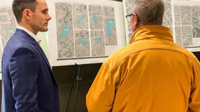 Spencer Croil with maps at community convo