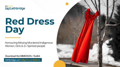 The image is a promotional poster for "Red Dress Day" by the City of Lethbridge. It features a red dress hanging from a tree branch, symbolizing the day to honor Missing Murdered Indigenous Women, Girls & 2+ Spirited people. The text on the poster reads: "Red Dress Day - Honouring Missing Murdered Indigenous Women, Girls & 2+ Spirited people. Download the MMIWG2S+ Toolkit lethbridge.ca/indigenousrelations".