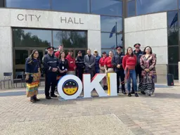 LPS and others with Oki sign at City Hall Census