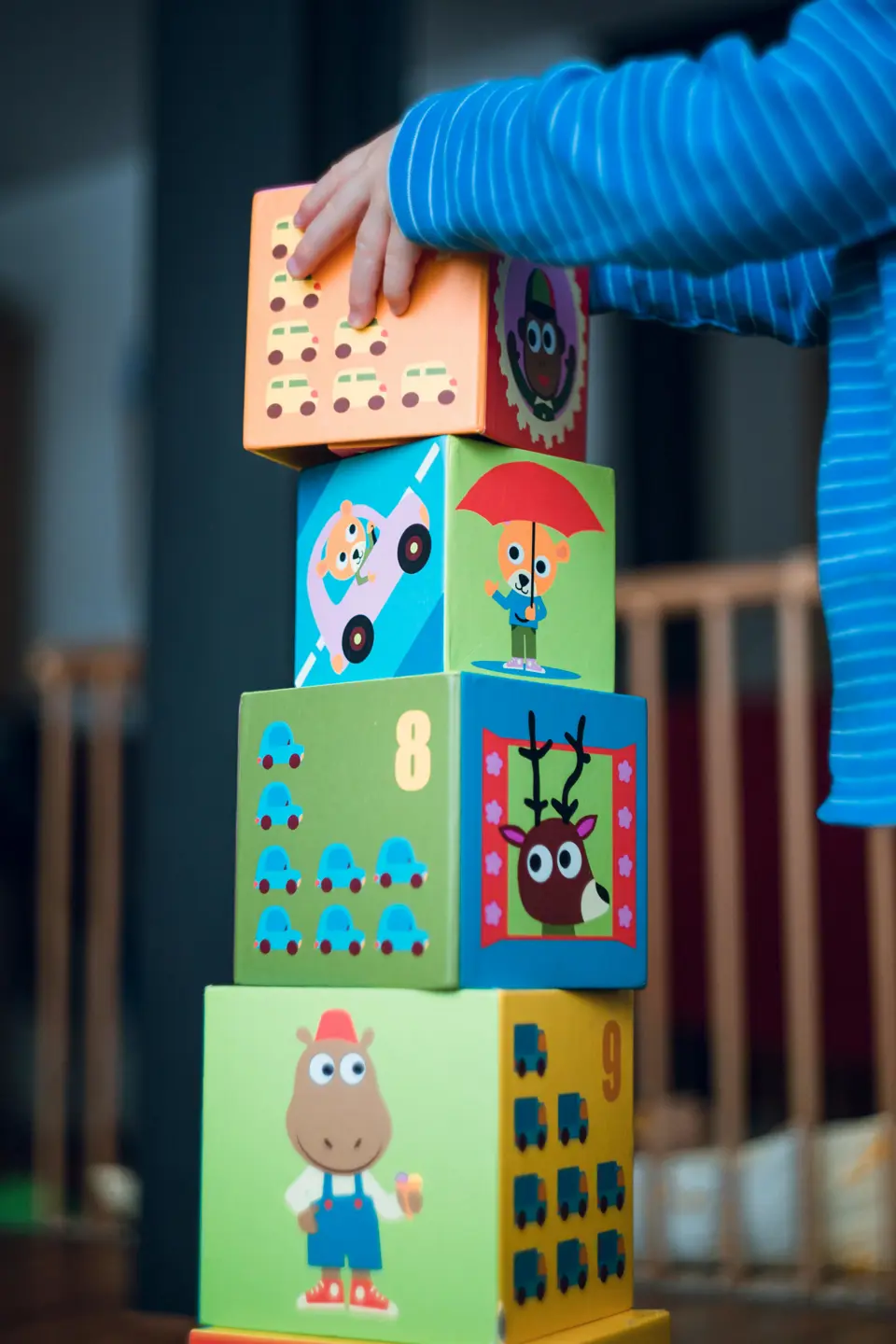 child stacking building blocks