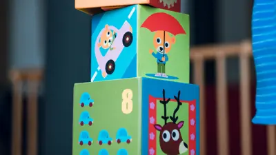 child stacking building blocks