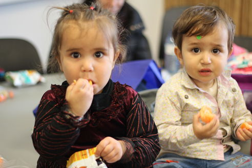 Two children eating on a table inside the Nature Centre.