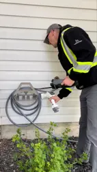 water meter check by employee garden hose reel