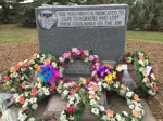 CUPE memorial headstone with flower wreaths