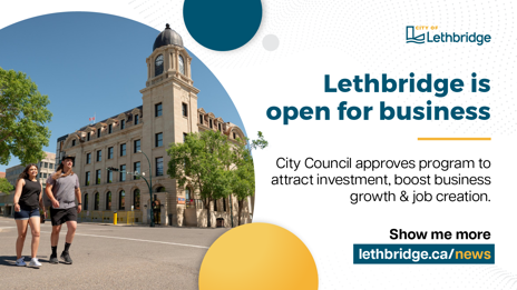 A promotional banner from the City of Lethbridge. On the left, two people walk past a historic building with a clock tower and a Canadian flag. On the right, bold blue text reads 'Lethbridge is open for business,' followed by 'City Council approves program to attract investment, boost business growth & job creation.' A call-to-action below says 'Show me more' with the website link 'lethbridge.ca/news.' The City of Lethbridge logo appears in the top right corner.