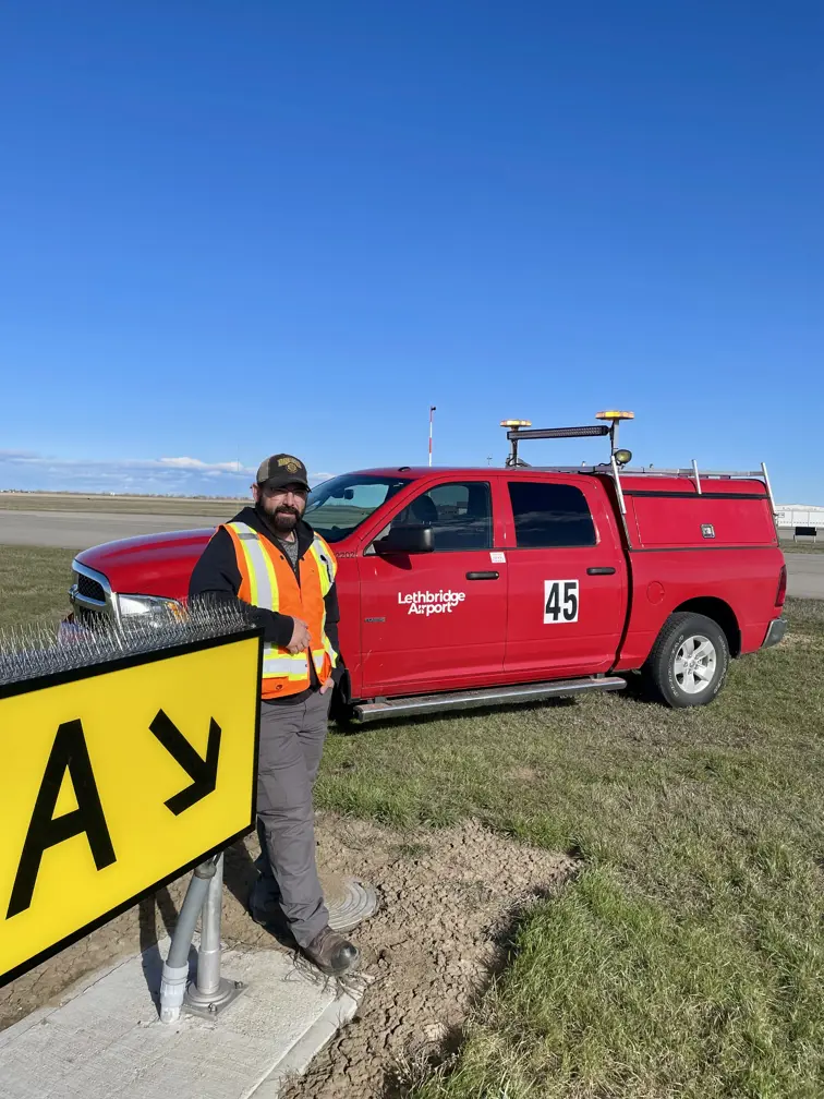Anthony Kish Lethbridge on runway with Airport fleet vehicle 