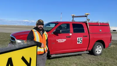 Anthony Kish Lethbridge on runway with Airport fleet vehicle