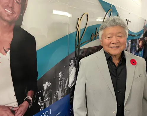 Ron Sakamoto beside Keith Urban poster