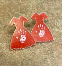 2 red dress pins on counter