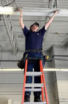RAP Student Nathan Sim installing duct work