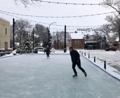 Skating rink at festival square with skaters