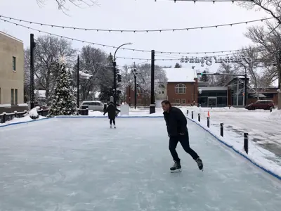 Skating rink at festival square with skaters