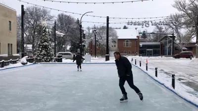 Skating rink at festival square with skaters