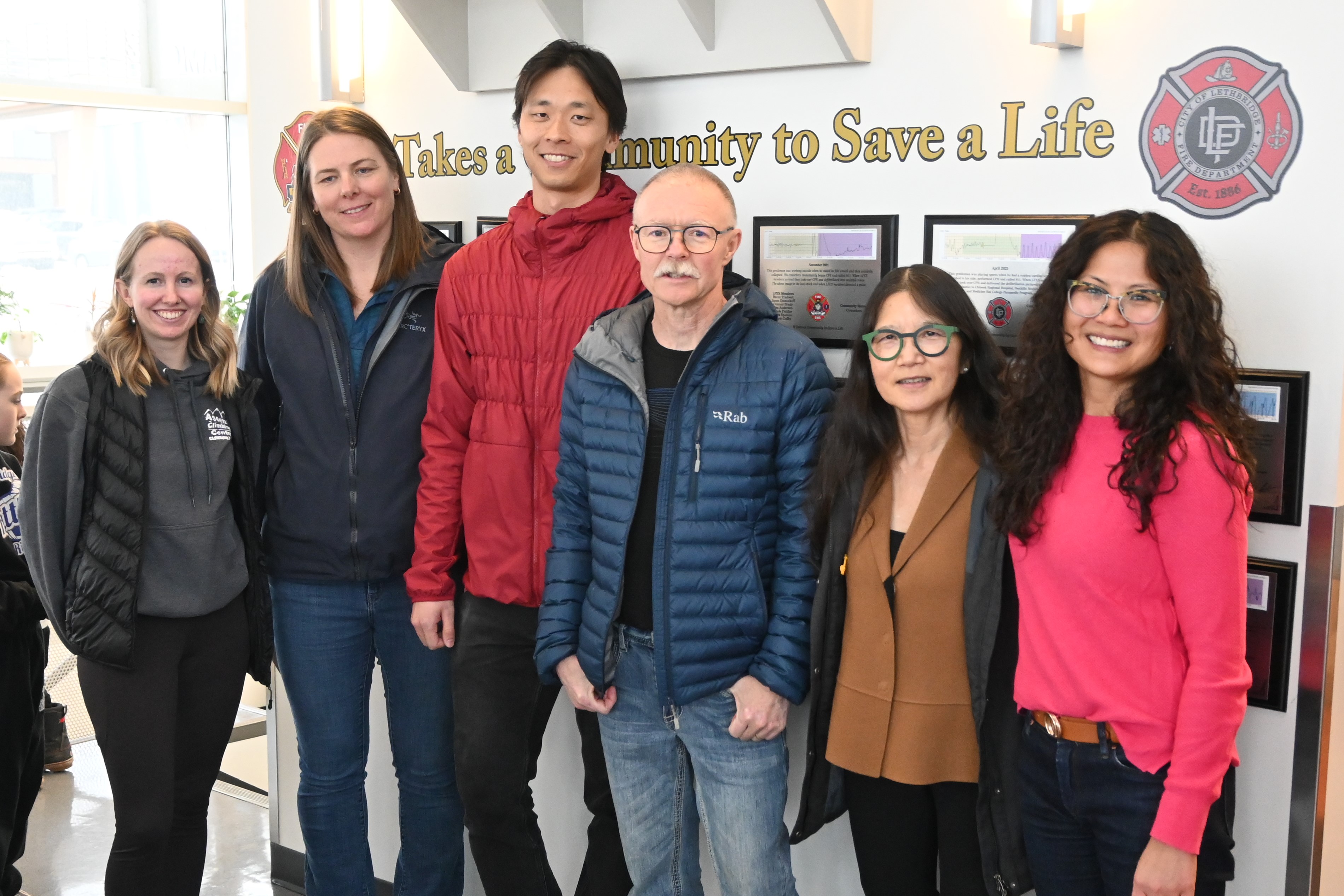 Ralph stands with the bystanders who recognized the emergency and began CPR, helping to set the chain of survival in motion.